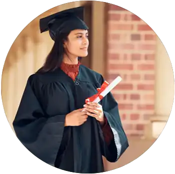A young woman with tan skin and dark hair wears a black cap and gown and holds a diploma.